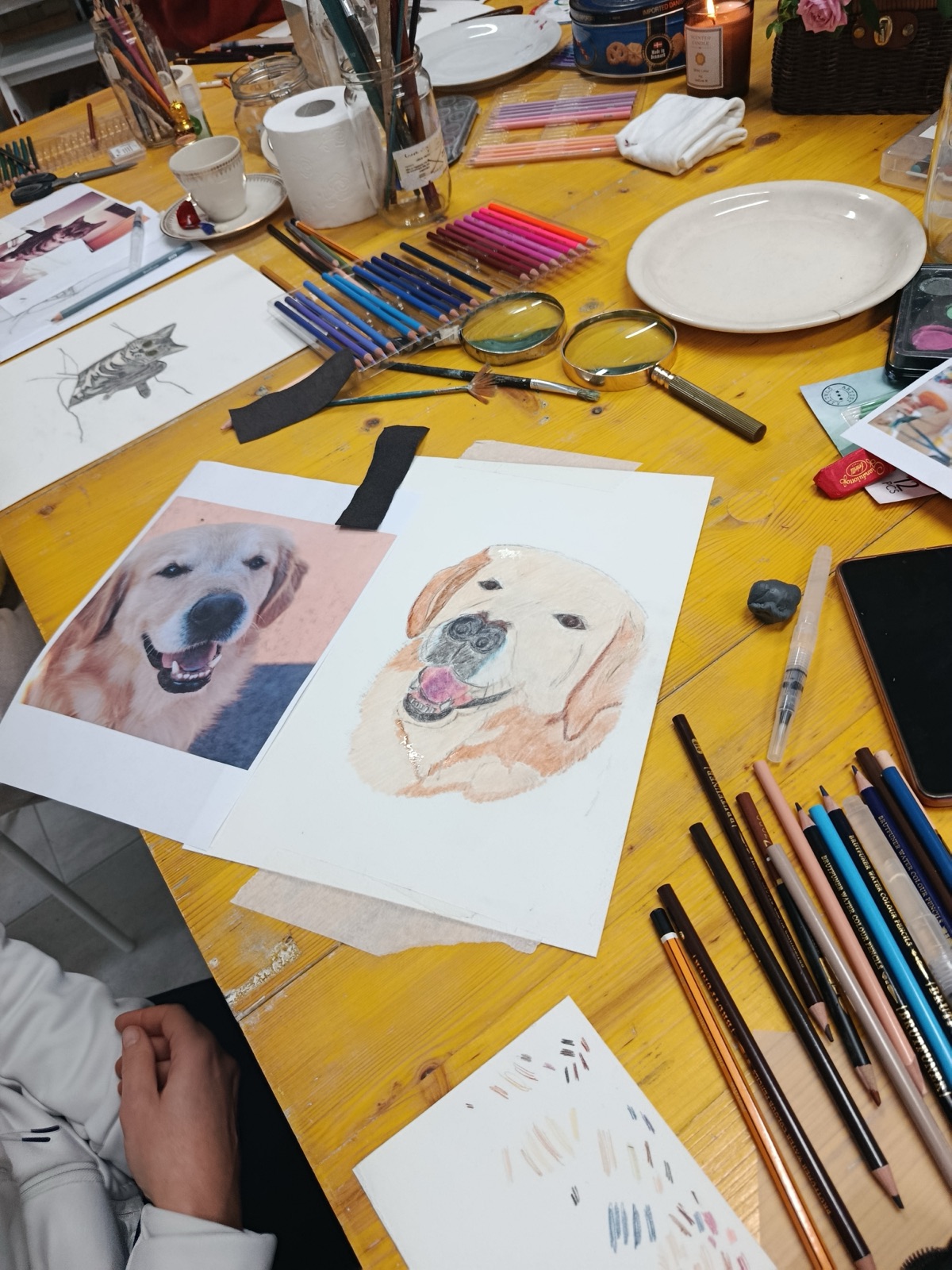 Watercolour pet portraits on a work table
